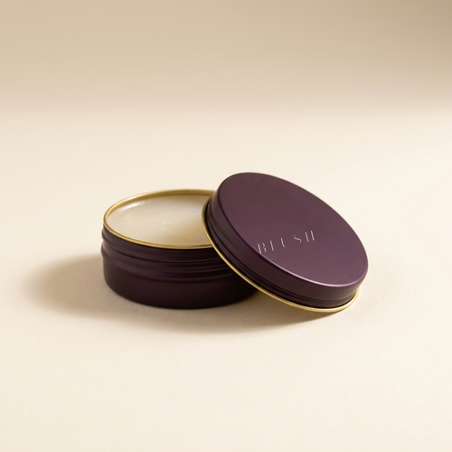 Blush Calcium Multi-Balm, plum tin with gold rim, lid resting open